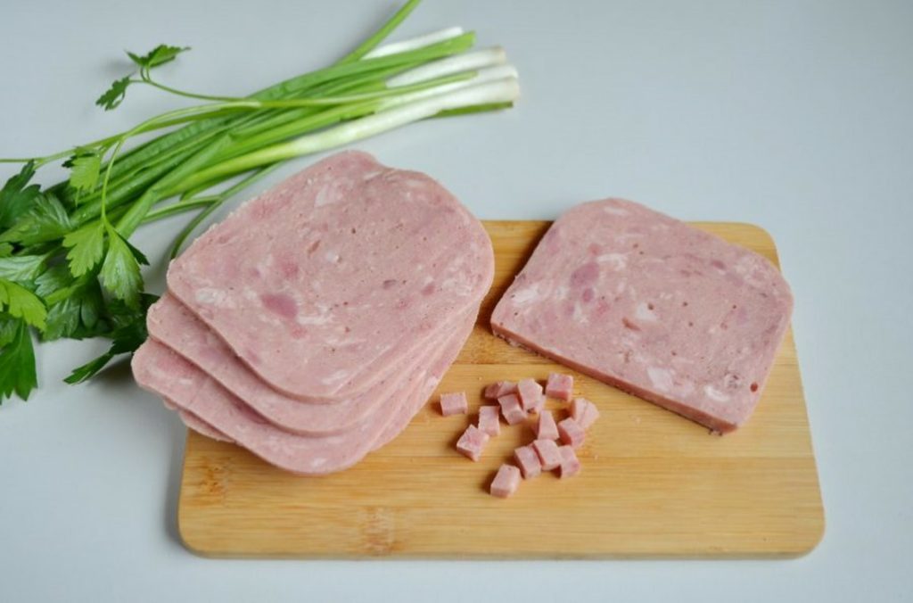 Can Dogs Eat Ham sliced ham on brown wooden chopping board